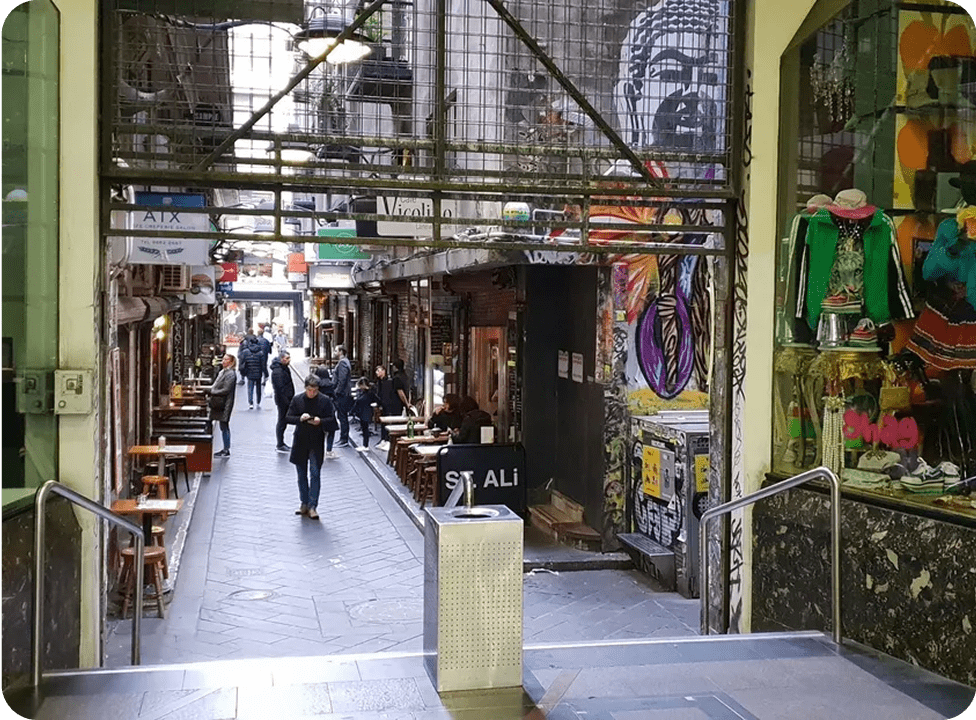 Narrow alleyway with cafes and graffiti art.