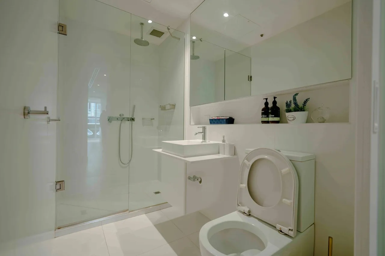 Modern bathroom with shower and toilet.